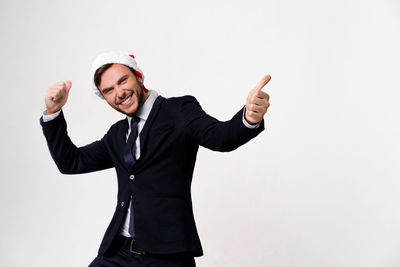 Smiling young man standing against white background