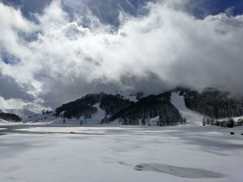 Scenic view of snowcapped mountains against sky