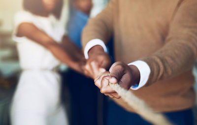 Midsection of man holding hands