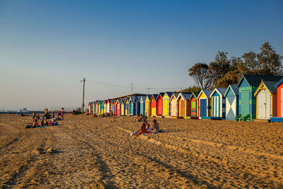 People at beach against sky