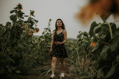 Young woman walking at sunflower farm