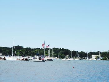 Calm sea against clear blue sky