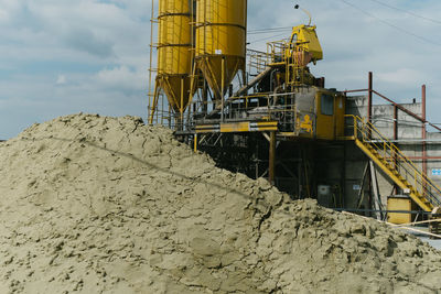 Low angle view of construction site against sky
