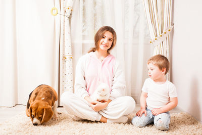 Happy friends sitting on floor