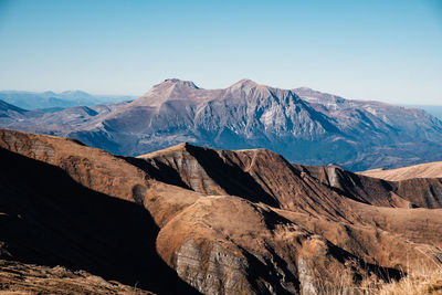 Scenic view of snowcapped mountains against clear sky