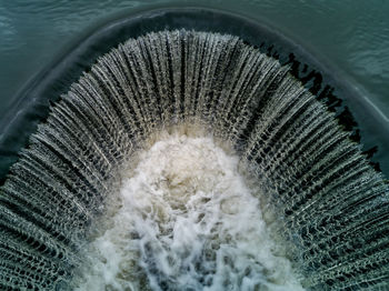 High angle view of water flowing on dam