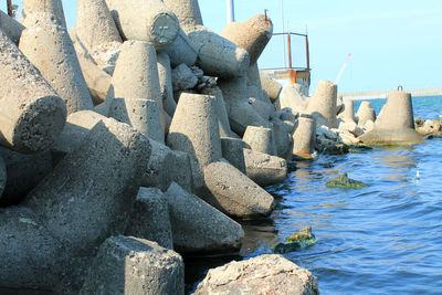 Rocks by sea against sky