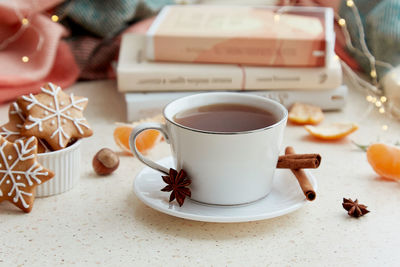 Cropped hand of woman holding coffee on table