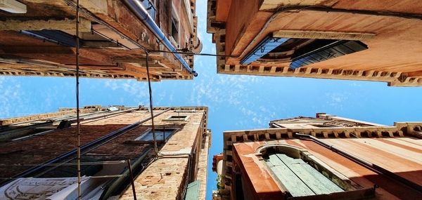 Low angle view of buildings against blue sky