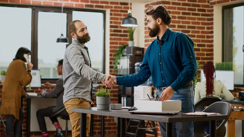 Side view of business colleagues working at office