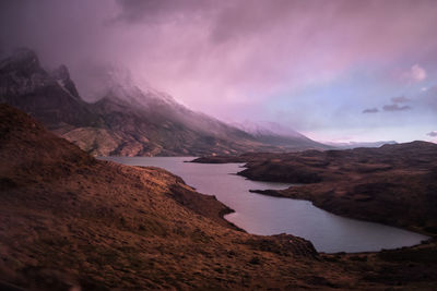 Scenic view of lake and mountains against sky