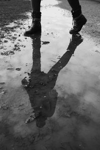 Low section of people standing in puddle