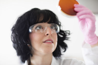 Young woman scientist portrait with gloves and safety glass