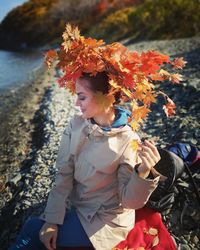 Woman standing by plants during autumn