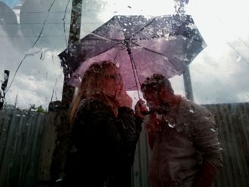 People standing on wet glass during rainy season