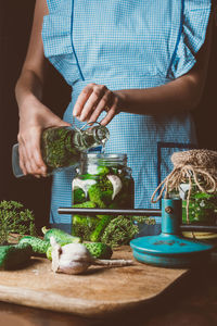 Midsection of man preparing food on table