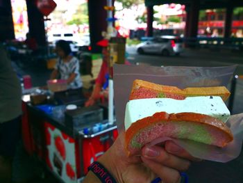 Close-up of woman holding hands at night
