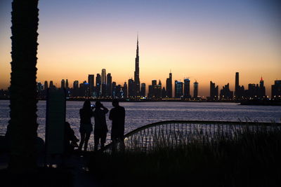 Silhouette of buildings against sky during sunset