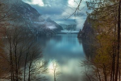 Scenic view of waterfall in forest against sky