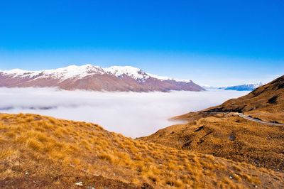 Clouds amidst mountains during winter