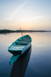 Boat moored on sea against sky