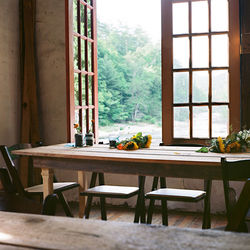 View of chairs at dining table by the window