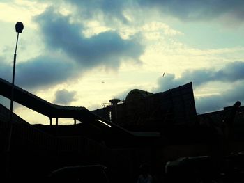 Low angle view of street light against cloudy sky