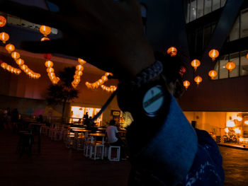 People sitting in illuminated city at night