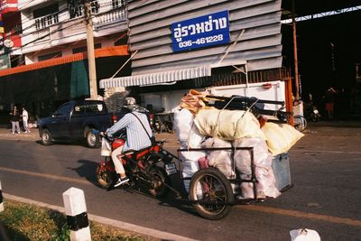 People riding motorcycle on road