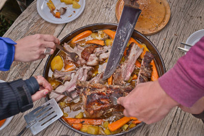 Close-up high angle view of hands eating food