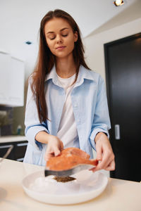 Portrait of smiling young woman using mobile phone