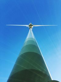 Low angle view of wind turbine against blue sky