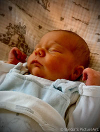 Cute baby sleeping on bed at home