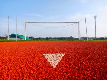 Surface level of soccer field against sky