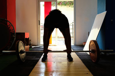 Rear view of man exercising at gym