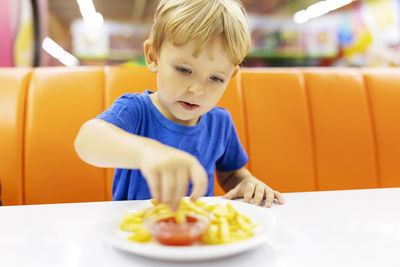 Portrait of cute boy eating food