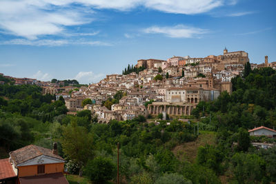 Buildings in town against sky