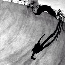 Low section of woman standing on skateboard