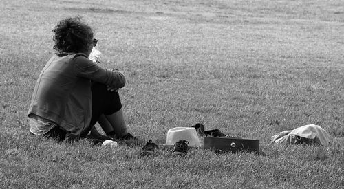 Man sitting on grassy field