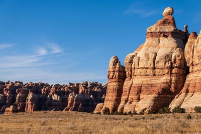 Rock formations on landscape against sky