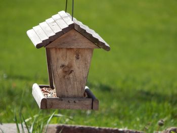 Close-up of birdhouse on field