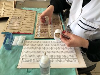 Midsection of scientist working at table