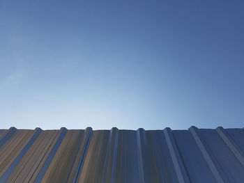 Low angle view of buildings against clear blue sky