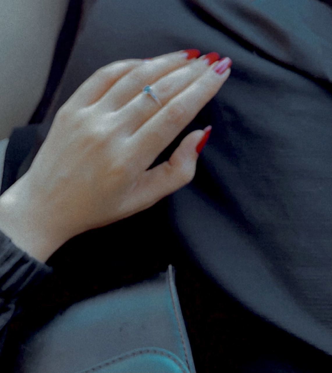 CLOSE-UP OF HAND ON WOMAN