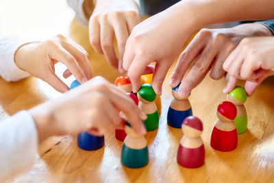 High angle view of children playing with figurines on table
