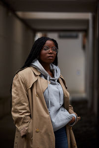 Young woman looking away while standing in winter