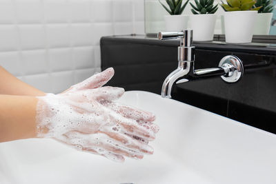 Close-up of faucet in bathroom