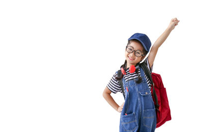 Smiling young woman standing against white background