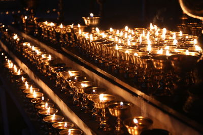 Illuminated tea light candles in building