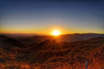 Scenic view of mountains against sky during sunset